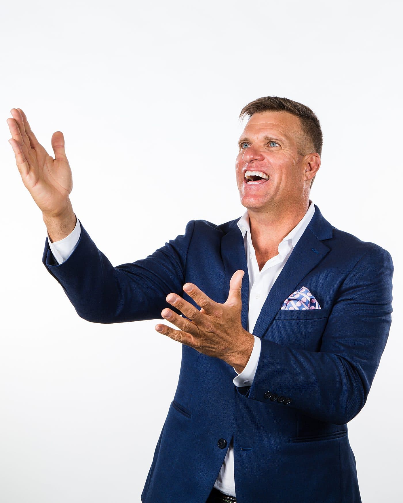 Dave VanHoose mid-presentation, both hands raised toward the headline